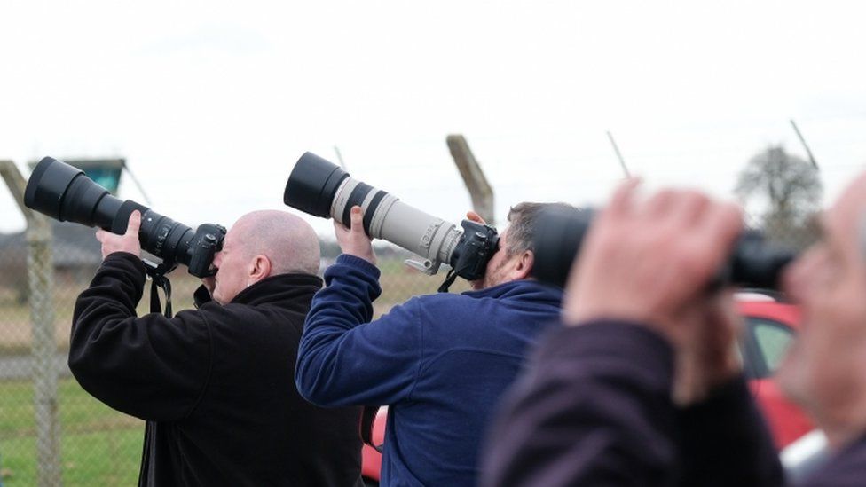 Aircraft enthusiasts wait to watch a fly past by RAF Tornado GR4 aircraft at a public viewing area on the perimeter of the RAF Leeming base on February 19, 2019 in Northallerton, England.