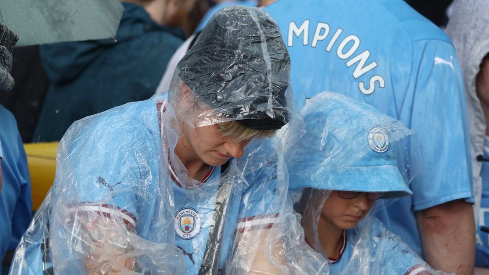 Thousands of Manchester City fans braved poor weather for the club's open-top parade celebrating its Treble