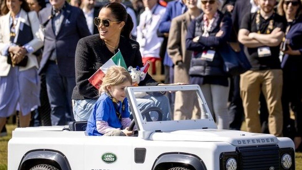 The Duchess of Sussex in a miniature car