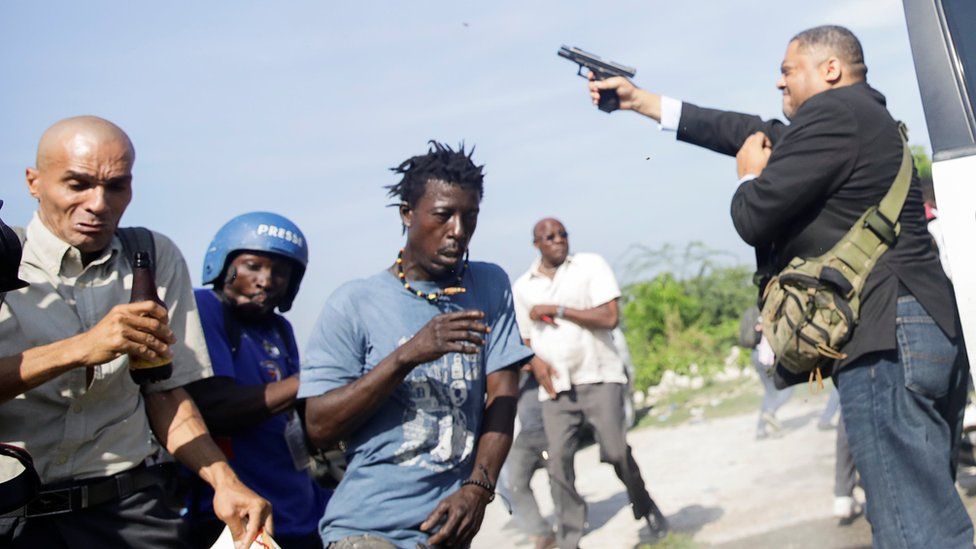 Senator Jean Marie Ralph Féthière holds a gun in the country's capital, Port-au-Prince