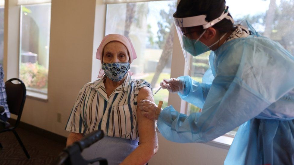 Irene Crow, 88, receives the coronavirus vaccine at Mission Commons assisted living community in Redlands, California