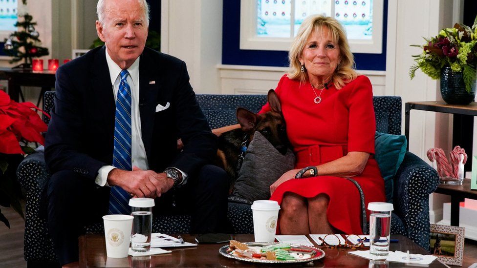 Commander, the Biden family's new puppy, is seen with US President Joe Biden and first lady Jill Biden as they meet virtually with service members in the Eisenhower Executive Office Building's South Court Auditorium at the White House, in Washington, U.S., December 25, 2021