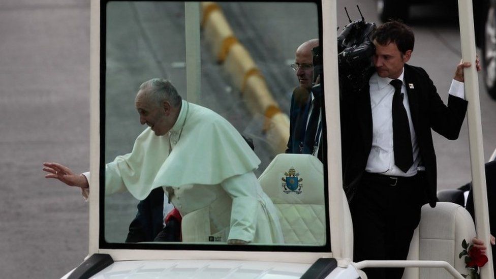 Pope Francis (L) greets people from his Popemobile after arriving at the CATAM airfield in Bogotá, Colombia, 06 September 2017.