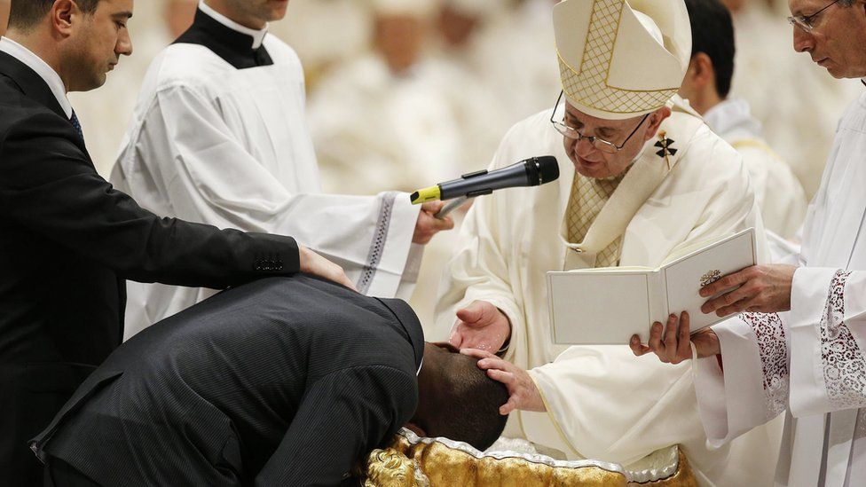Pope Francis baptizes Nigerian John Francesco Ogah during a solemn Easter vigil ceremony in St. Peter"s Basilica at the Vatican.