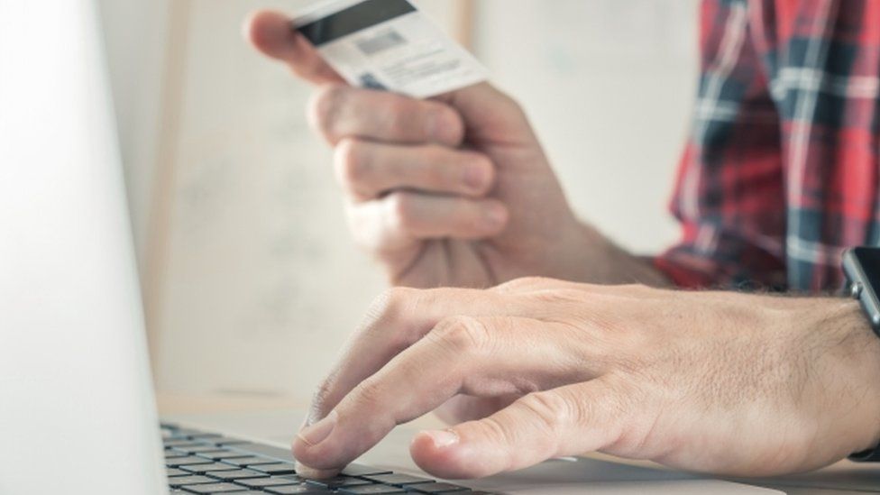 Man typing credit card details out
