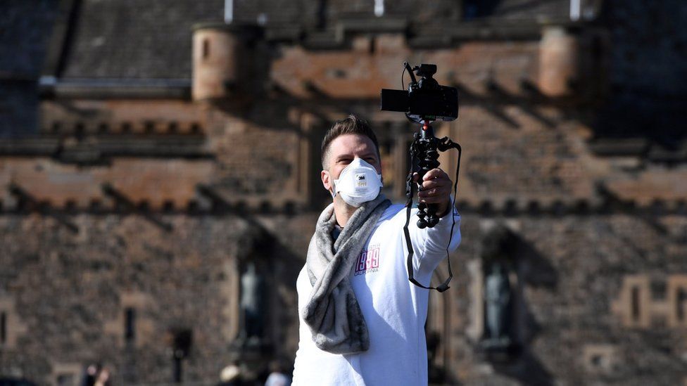 a visitor outside Edinburgh Castle