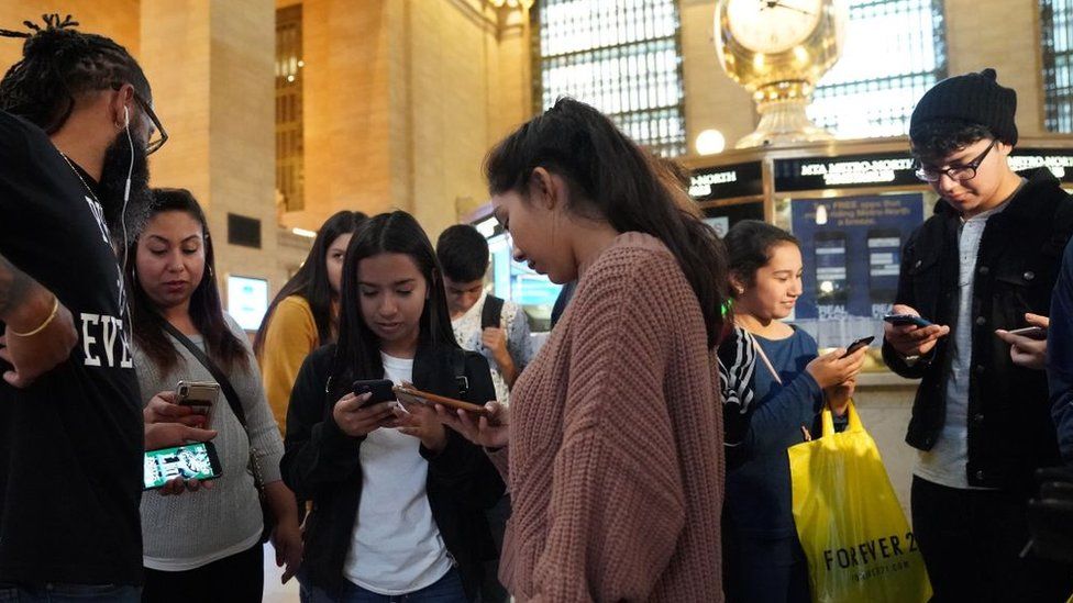 People look at their phones during the alert in New York's Grand Central Station