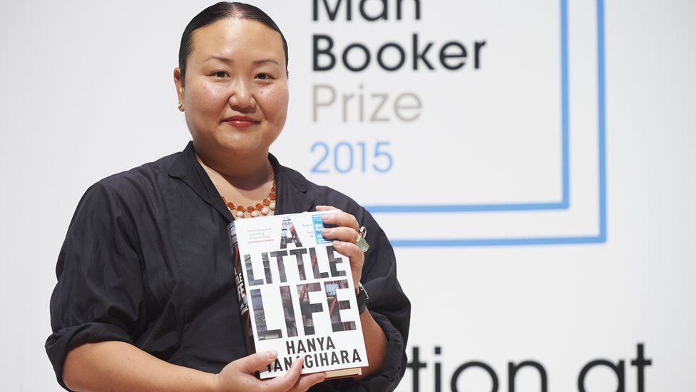 Author Hanya Yanagihara holding her book A Little Life at a photocall for the Booker Prize 2015