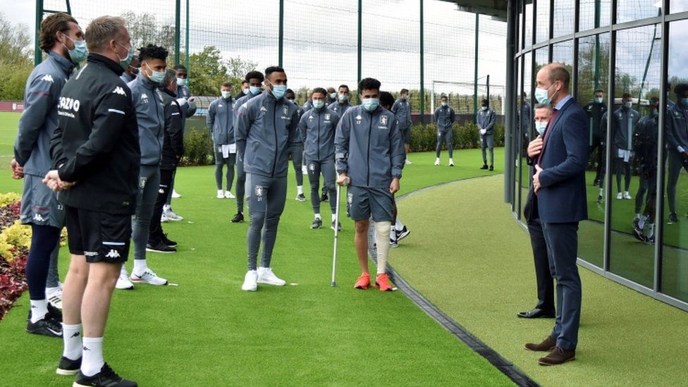 Prince William, Duke of Cambridge, speaks to Aston Villa players during a visit to the club's high performance centre at Bodymoor Heath