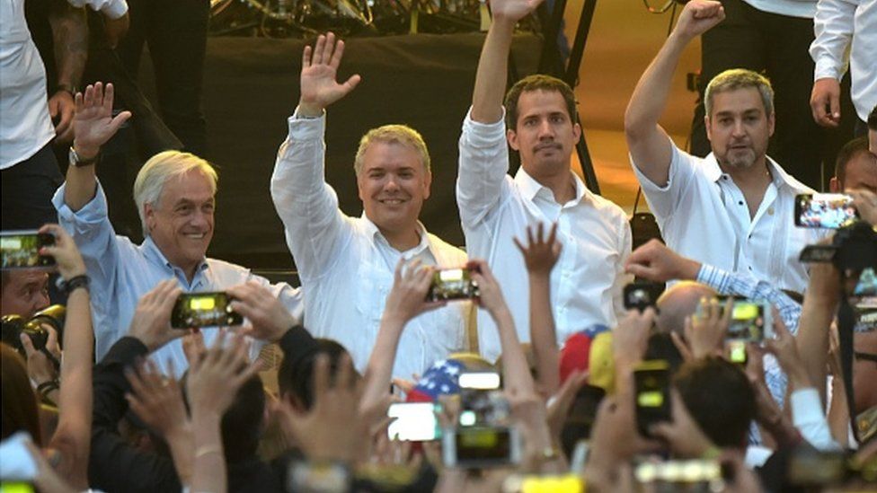 Chilean President Sebastian Pinera, Colombian President Ivan Duque, Venezuela's opposition leader Juan Guaido and Paraguayan President Mario Abdo Benitez wave at the 'Venezuela Aid Live' concert.