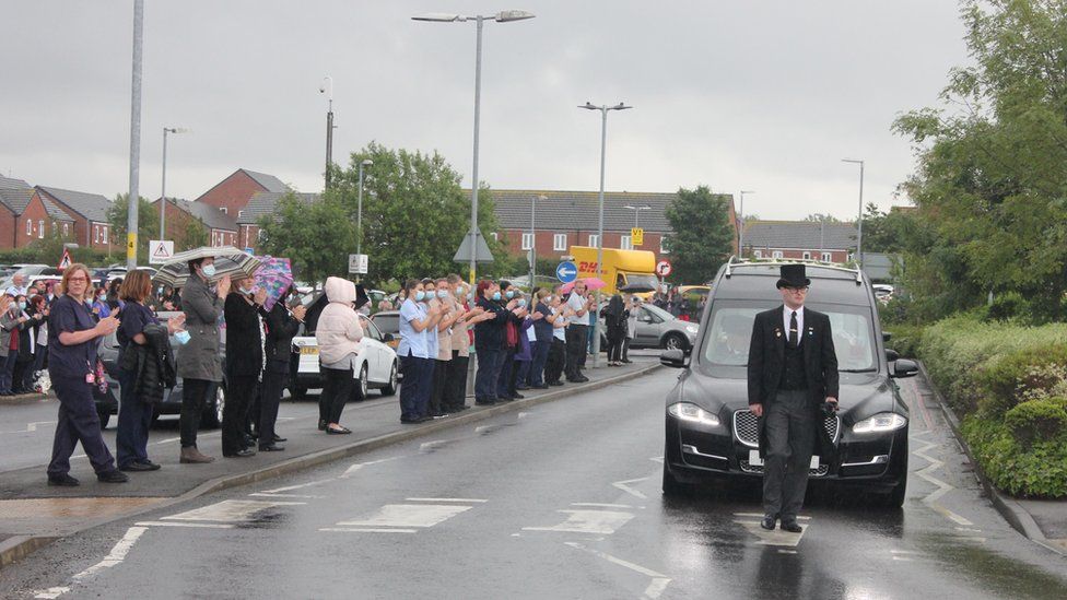 Well-wishers line the street as the funeral car carrying Mark Lowe drives slowly past