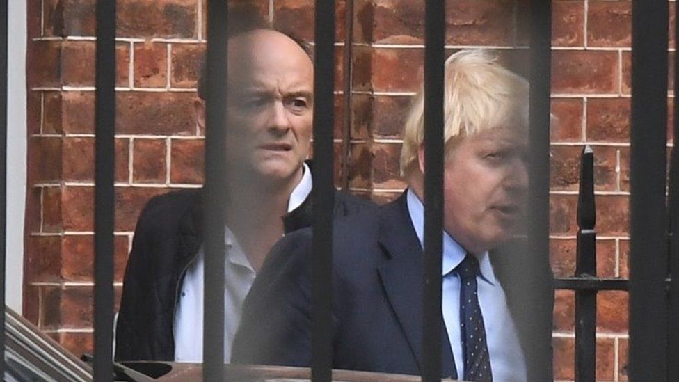 Dominic Cummings and Boris Johnson leaving from the rear of Downing Street in 2019