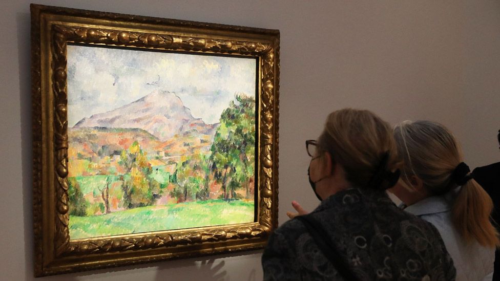 People looking at La Montagne Sainte-Victoire by French artist Paul Cezanne