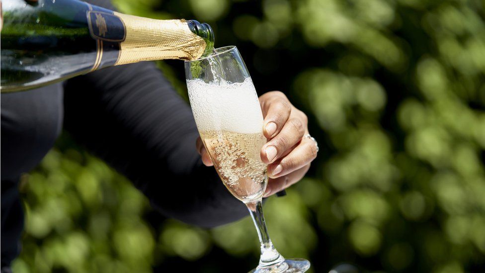 Champagne is poured into a glass