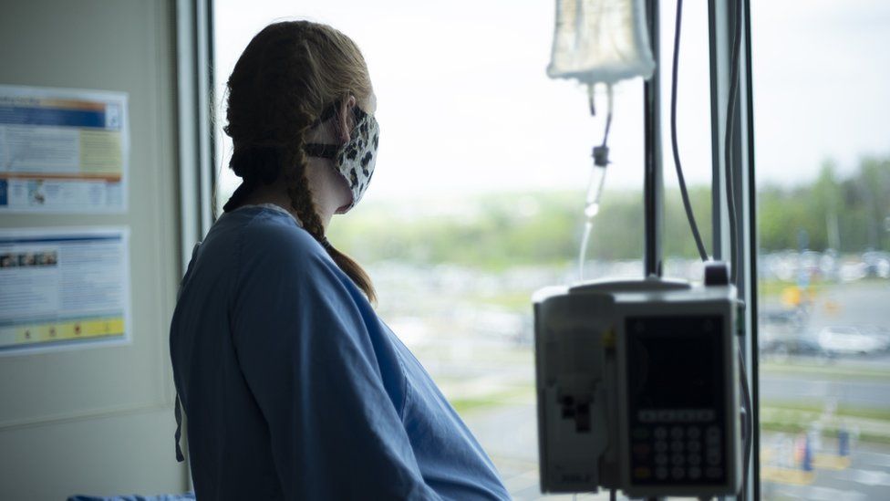 stock image of pregnant woman with mask in hospital