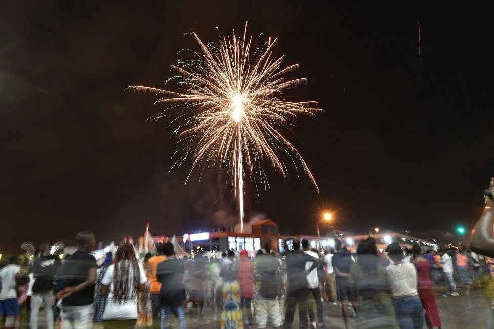 Ivorians watch a fire works display to ring in the New Year, in Koumassi a neighbourhood of Abidjan on 1 January 2021