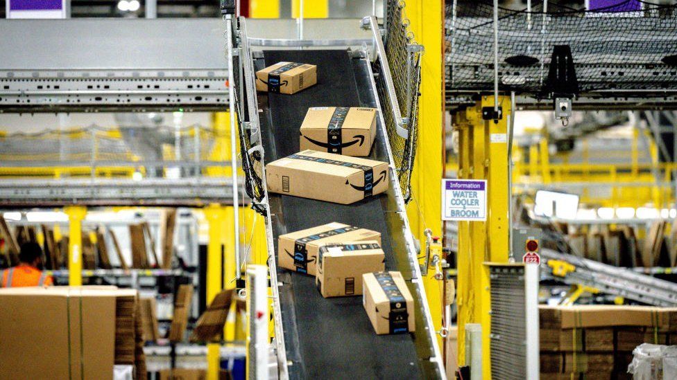 Packages move along a conveyor at Amazon fulfillment center in Eastvale