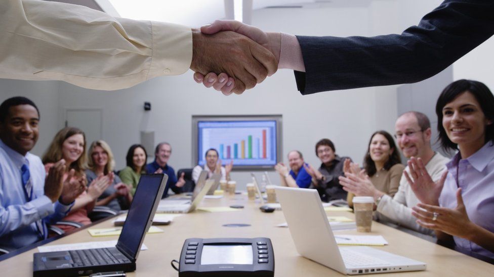 Handshake in boardroom
