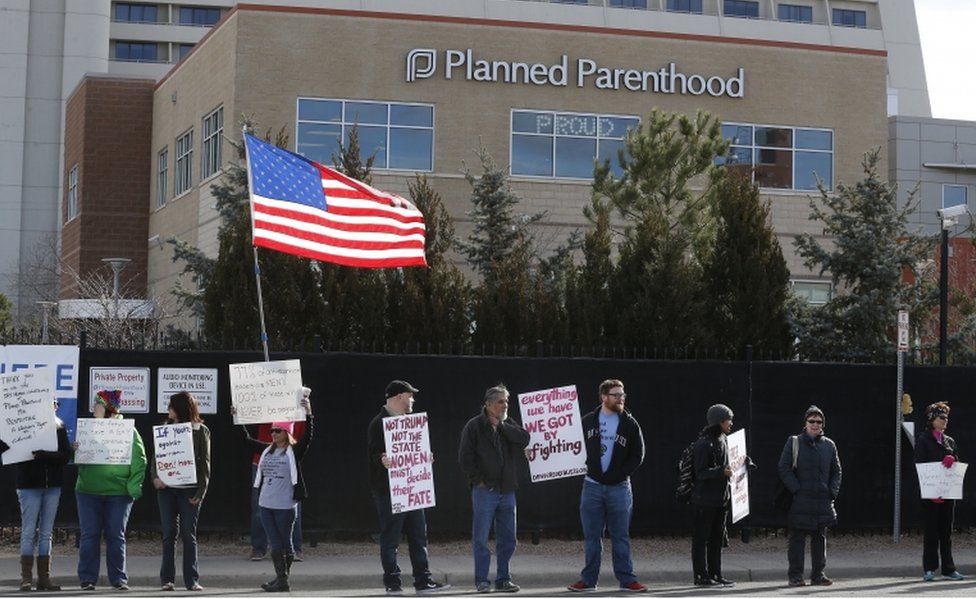 Pro-choice counter-protesters hold signs supporting a woman's right to choose abortion, as nearby anti-abortion activists held a rally in front of Planned Parenthood of the Rocky Mountains, in Denver, Saturday, Feb. 11, 2017.