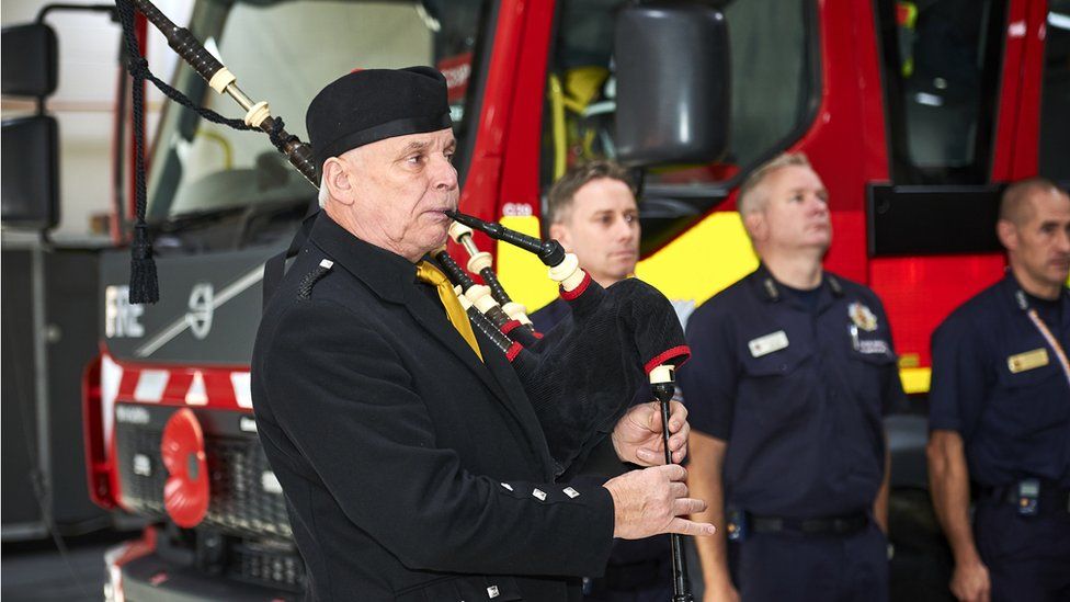 FBU piper performs recital at ceremony in front of fire engine