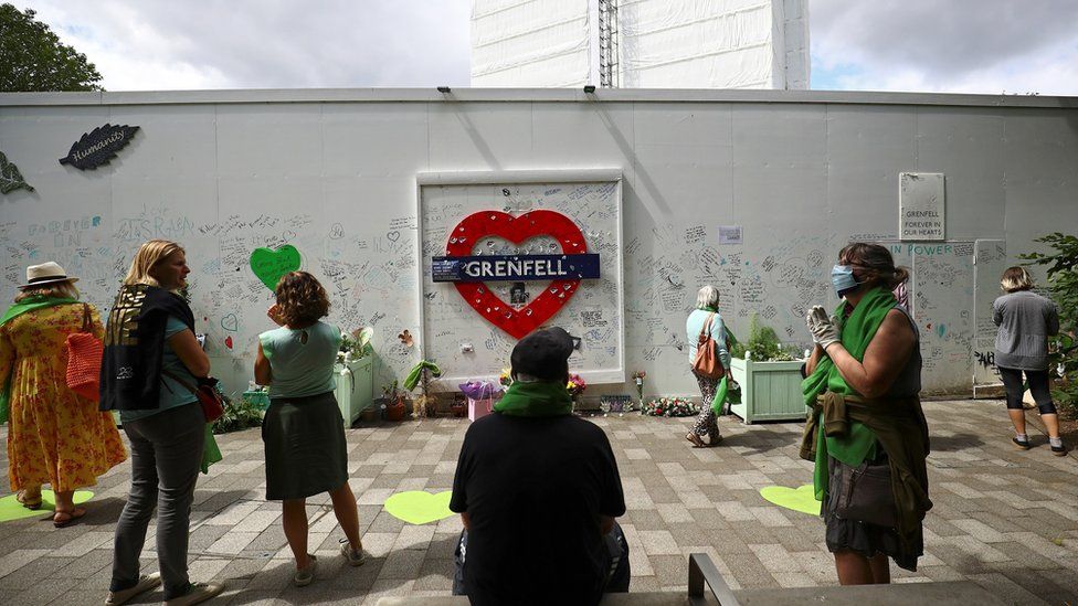 People attend a commemoration to mark the third anniversary of the Grenfell Tower fire in London