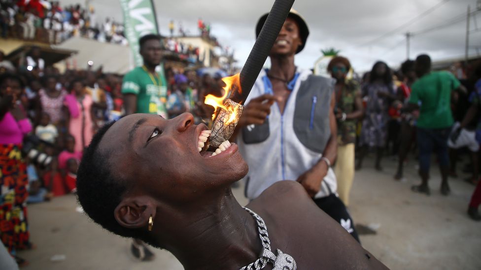A fire eater performing at a carnival in Bonoua, Ivory Coast - 30 April 2022