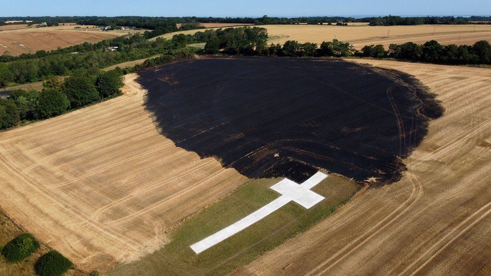 An aerial view of the aftermath of a fire in a field that came close to engulfing the Lenham Cross war memorial in Kent