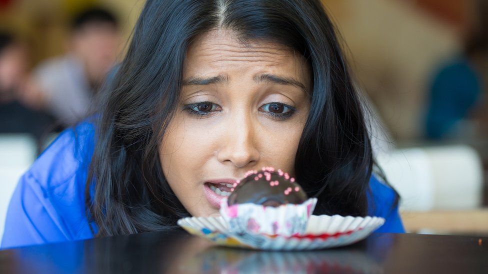 Woman looking at a cake