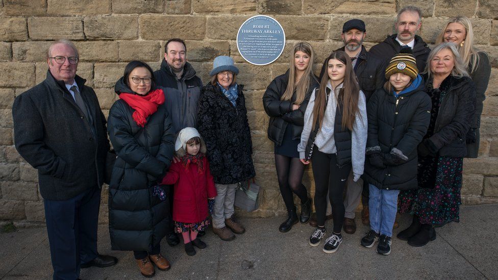 Members of Mr Arkley's family standing alongside the newly unveiled blue plaque