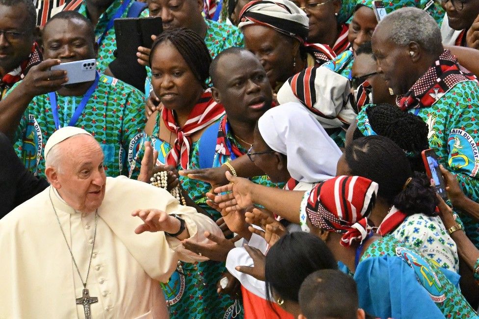 Pope Francis is greeted by people from Burkina Faso during his weekly general audience at Paul VI hall in the Vatican.