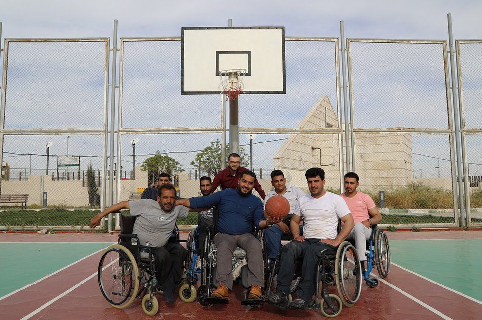 A group of men on the basketball pitch.