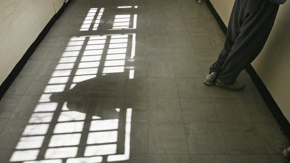 Prisoner looking through a window