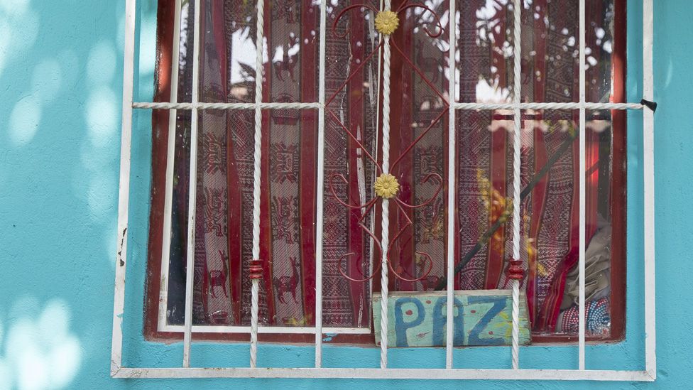 A sign reading "peace" sits in the window of a home in the City of Women on 20 January, 2020.