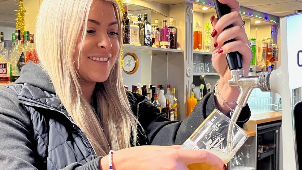 Woman serving at bar