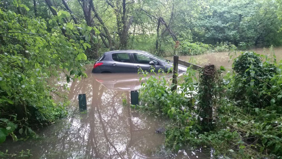 A car is trapped in a flooding at a lane in Southampton, UK