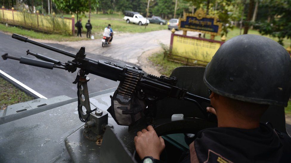 A Thai soldier takes up position outside the Rattanaupap temple in Narathiwat province, 19 January 2019