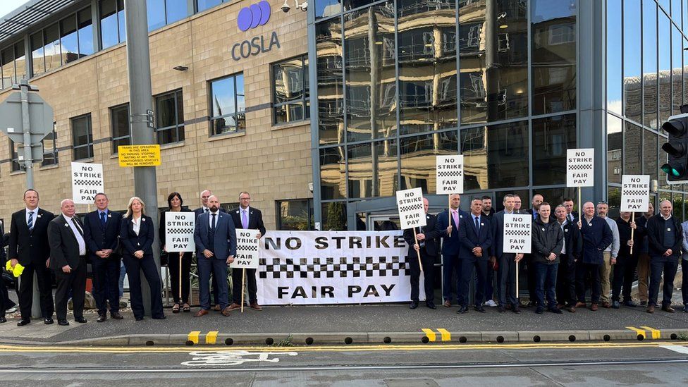 Off-duty officers and Scottish Police Federation officials protest outside