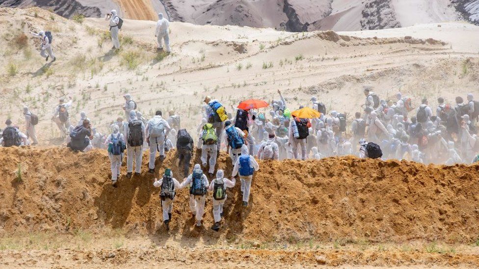 Activists run into the grounds of the mine