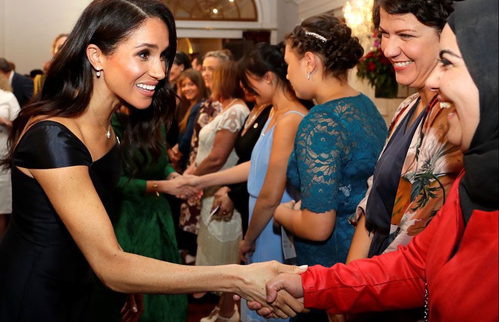 Meghan greeting guests at a reception to celebrate the anniversary of women's suffrage