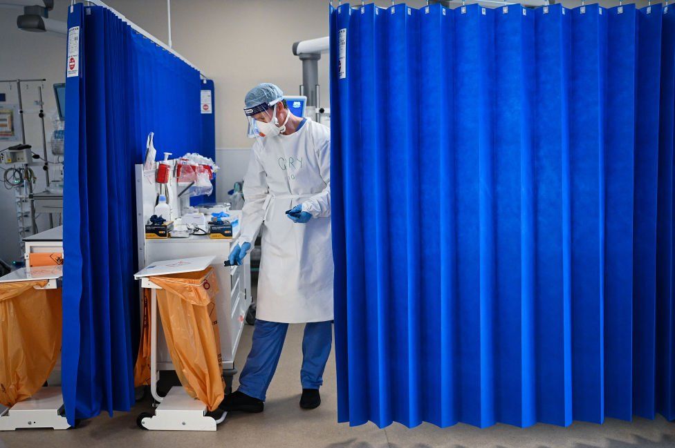 A nurse at University Hospital Monklands disposes of medical waste on the ICU ward on 5 February 2021 in Airdrie, Scotland.