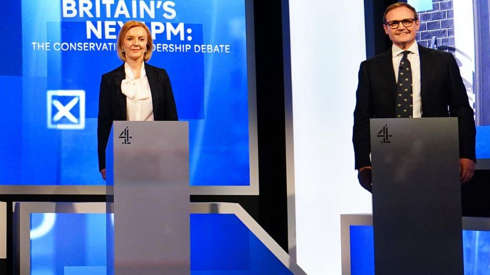 Tom Tugendhat and Liz Truss stand side by side at their podiums during a Channel 4 leadership debate