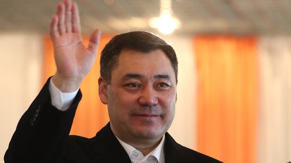 Presidential candidate Sadyr Japarov waves at the press after casting his ballot during the presidential elections in Bishkek, Kyrgyzstan, 10 January 2021