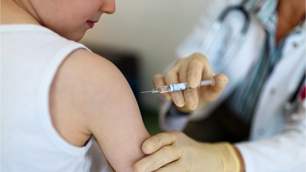 A child receives a vaccine