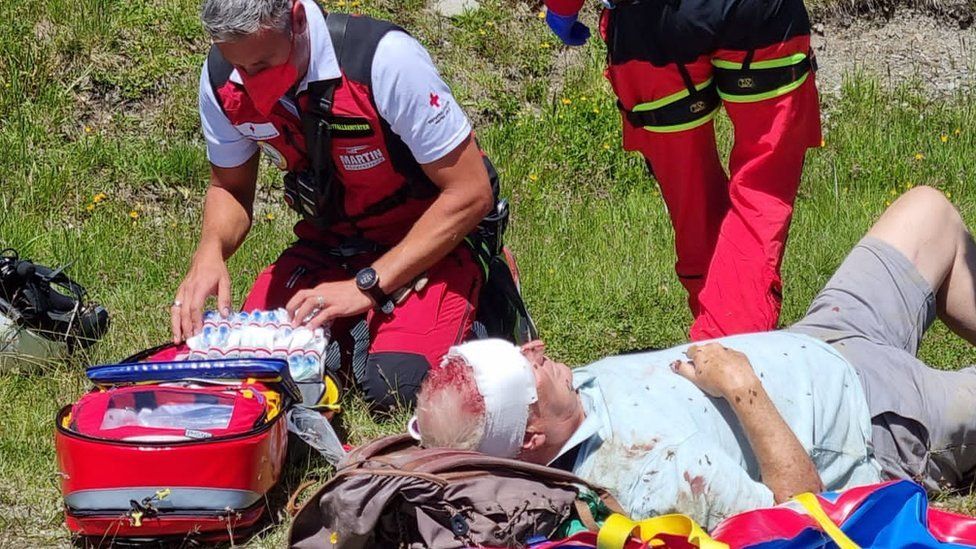 Alan Couser receives treatment from medical helicopter staff in the Swiss Alps.