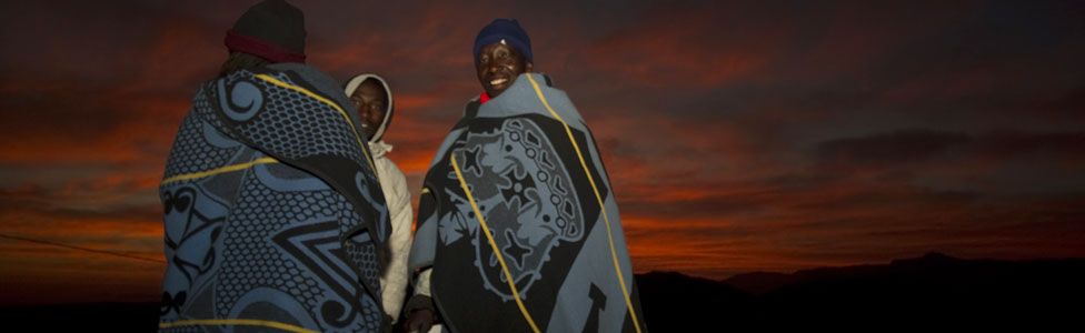 Men in Lesoth at dawn wearing traditional blankets
