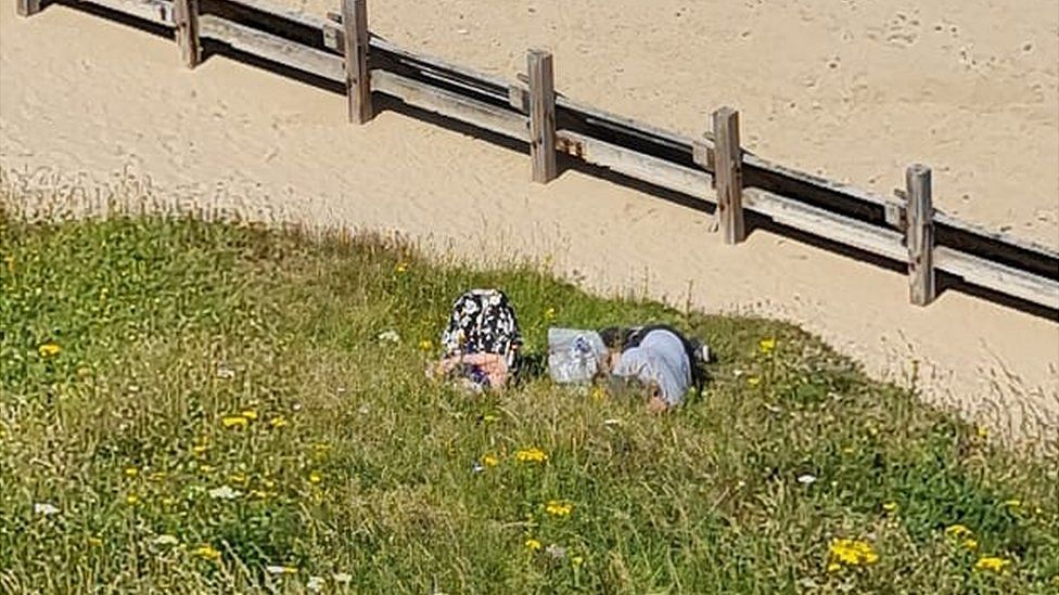 Couple Warned Over Sunbathing Close To Mundesley Cliff Edge Bbc News