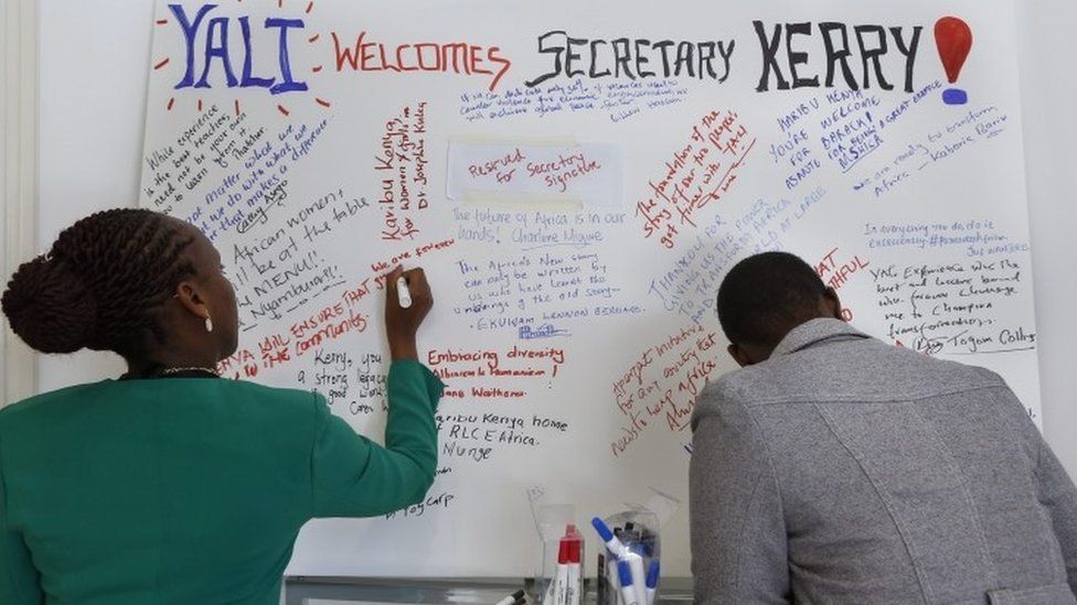 Kenyans write welcome messages for US Secretary of State John Kerry at a hotel where Kerry is having a ministerial meeting with his African counterparts in Nairobi, Kenya, 22 August 2016