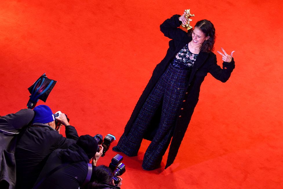 Director Mati Diop poses with the Golden Bear for Best Film for 'Dahomey', on the red carpet, after the award ceremony of the 74th Berlinale International Film Festival, in Berlin, Germany, February 24, 2024.