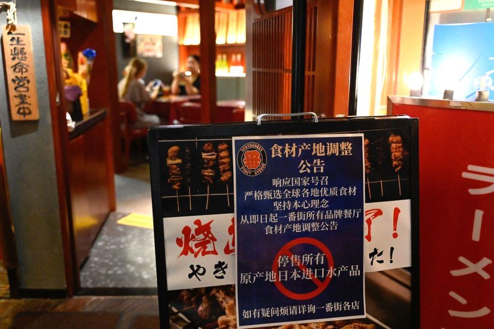 This picture shows a sign reading "Suspend the sale of all fish products imported from Japan" an area of Japanese restaurants in Beijing on August 27, 2023