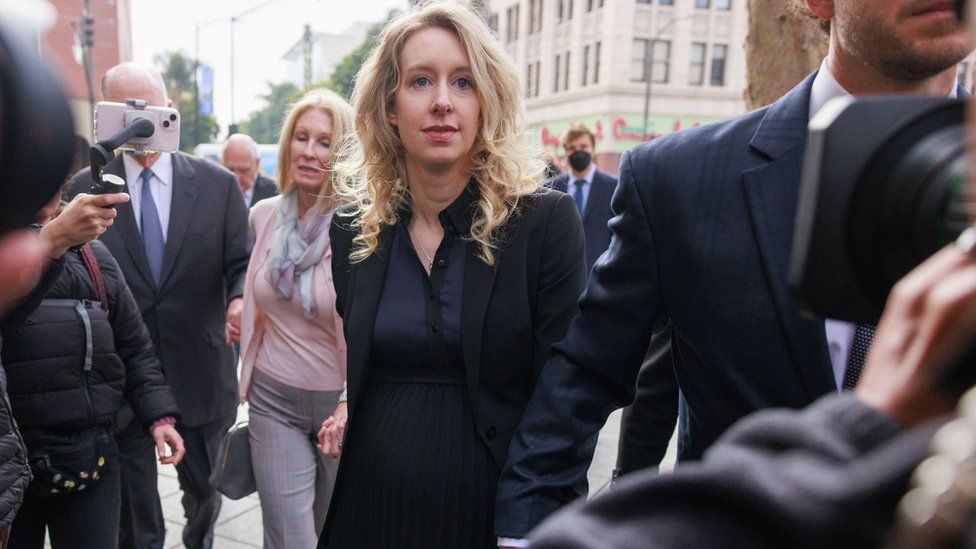 Elizabeth Holmes walks to her sentencing